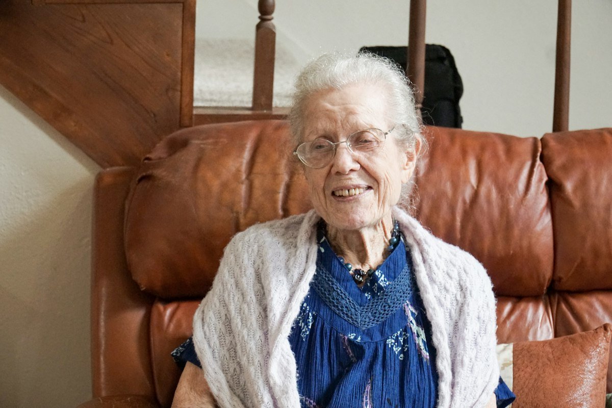 Happy elderly resident relaxing on a sofa